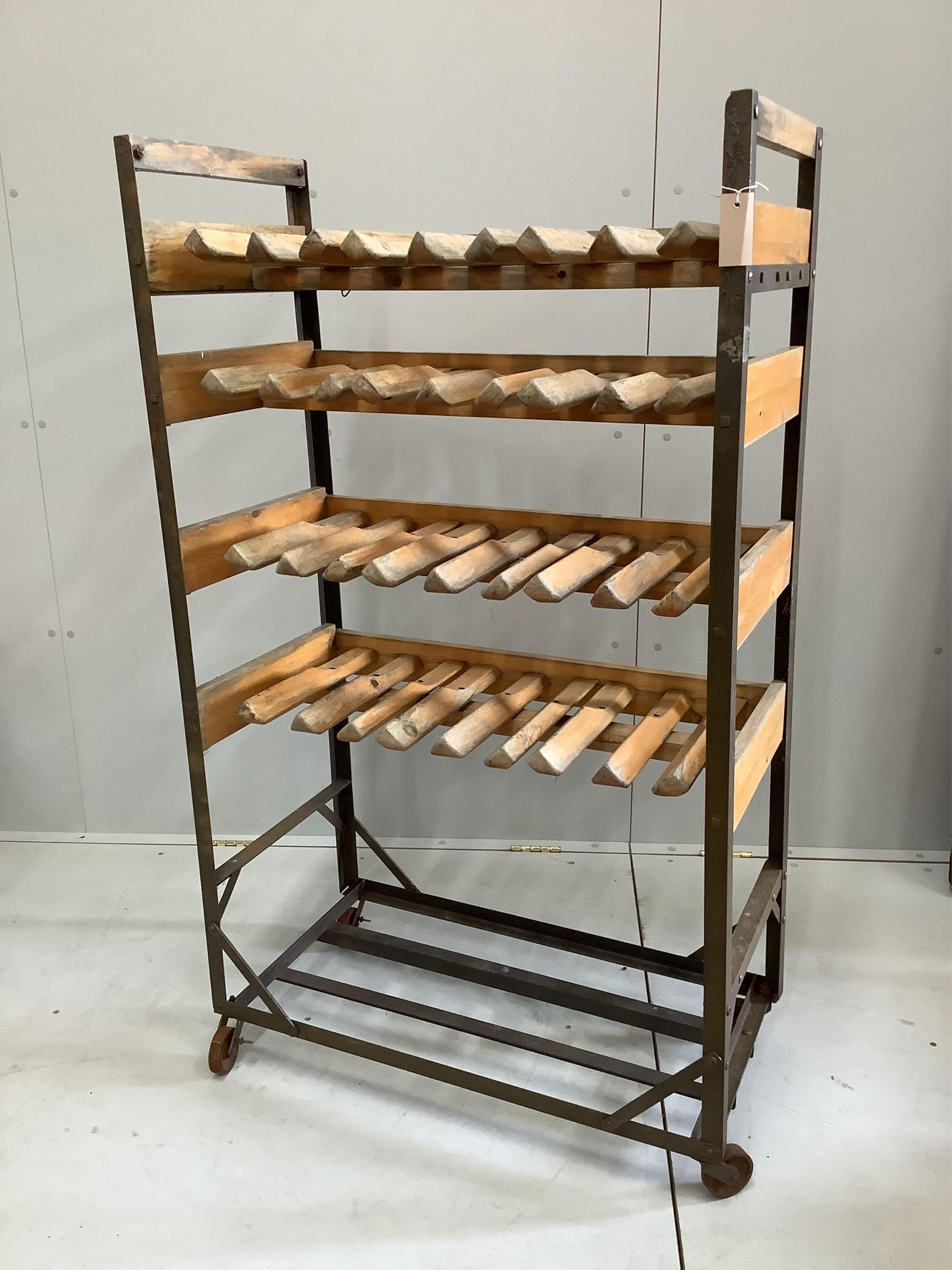 An early 20th century French slatted wrought iron baker's rack, width 81cm, depth 40cm, height 137cm. Condition - fair